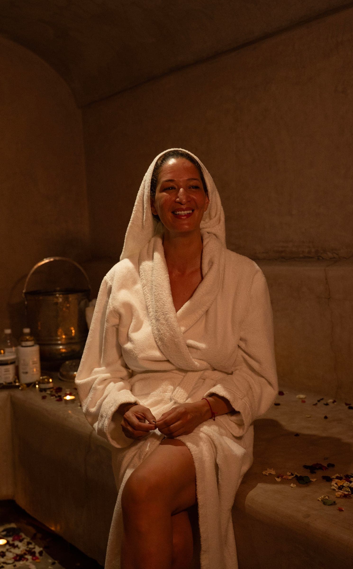 A guest wrapped in a robe, smiling